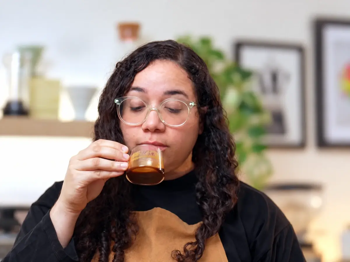 Liz tasting espresso in her real coffee space